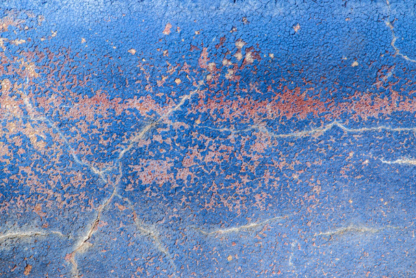 Faded indigo paint cracked wall closeup as blue background - Photo, Image