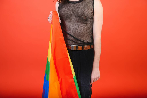Happy gay man having fun holding rainbow flag symbol of LGBTQ community. - Zdjęcie, obraz