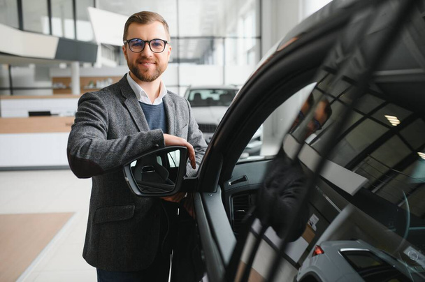 Portrait of happy customer buying new car - Foto, Bild
