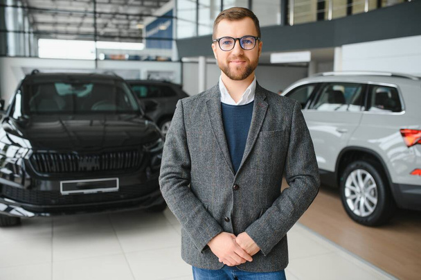 Portrait of happy customer buying new car - Foto, imagen