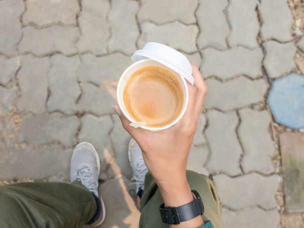 Hand holding hot of coffee cup lifestyle of eating and drinking coffee outside - Photo, Image