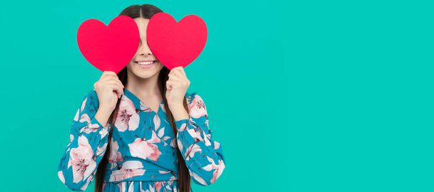 smiling child hold red heart symbol of love for valentines day, valentine. Kid girl portrait with heart love symbol, horizontal poster. Banner header with copy space - Fotoğraf, Görsel