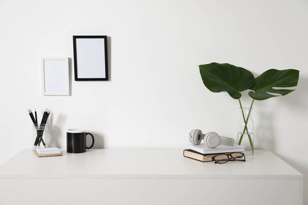 Comfortable workplace with white desk near wall at home - Fotoğraf, Görsel