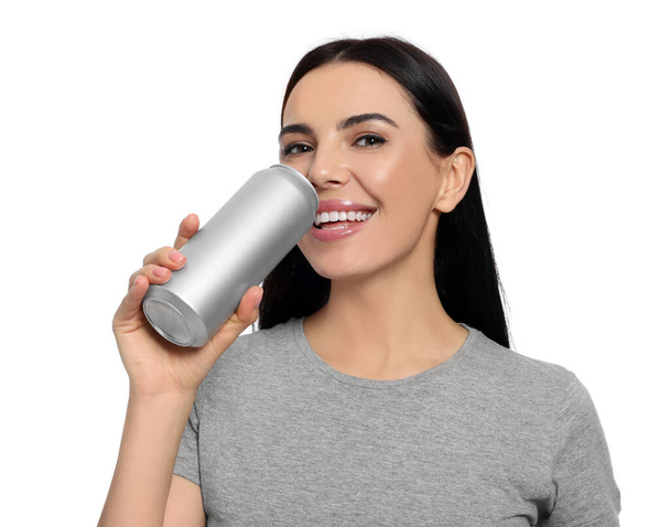 Beautiful happy woman drinking from beverage can on white background - Фото, изображение