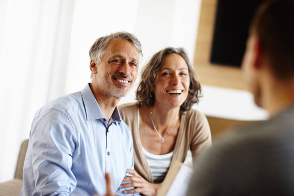 Thats great news. a happy mature couple talking to an advisor - Photo, Image