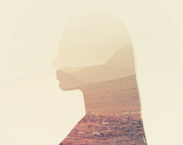 What lies within. Composite image of a rugged nature scene superimposed on a womans profile - 写真・画像