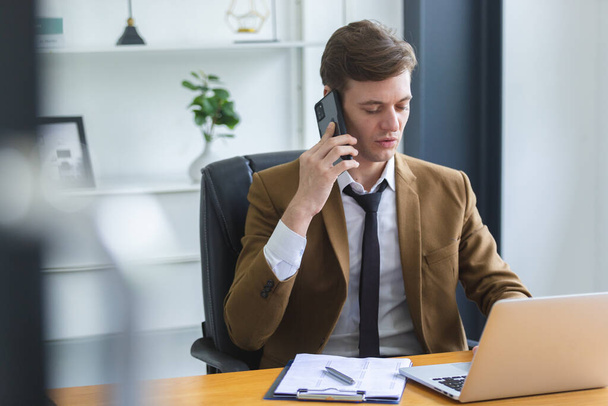 Smart businessman calling telephone at office table. Executive manager talking cell phone. handsome manager sitting at office table. - Photo, Image