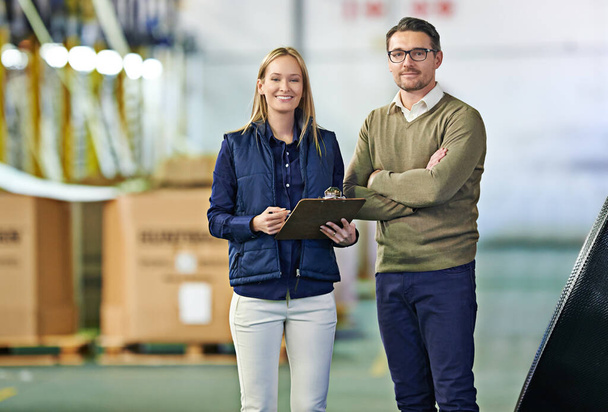 You can trust us to handle an job. a two coworkers managing a warehouse - Valokuva, kuva