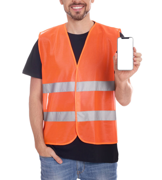 Male industrial engineer in uniform with phone on white background, closeup - Fotografie, Obrázek