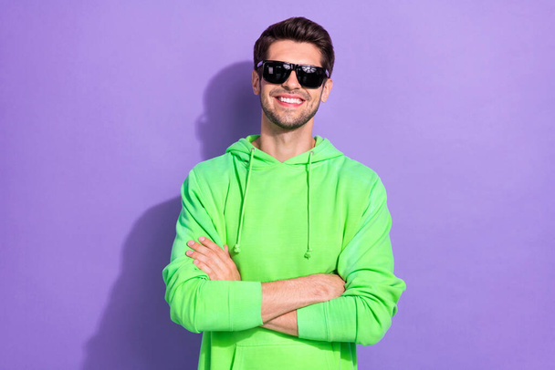 Photo of rich positive influencer hold folded hands wear green pullover expensive sunglasses rayban nightclub isolated on purple color background. - Photo, Image