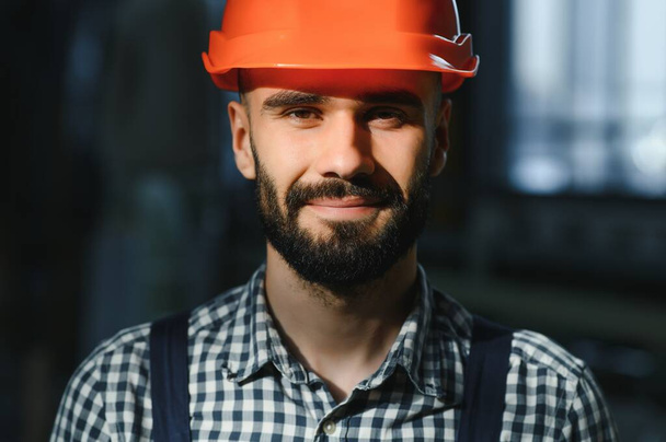 Portrait of factory worker in protective equipment in production hall - Φωτογραφία, εικόνα