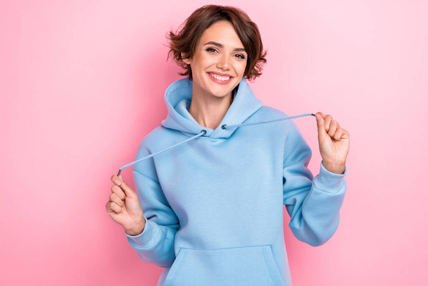 Photo of cool pretty lady person wear blue sports clothes hold laces show bright grin good mood isolated on pink color background. - Zdjęcie, obraz