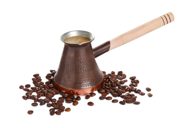 Metal turkish coffee pot with hot drink and beans on white background - Φωτογραφία, εικόνα