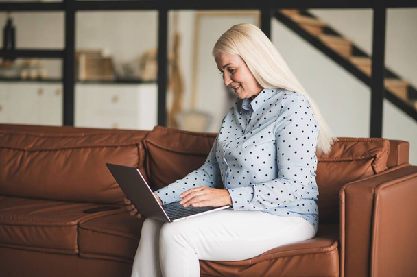 Work from home. Blonde woman working on the laptop - Photo, Image