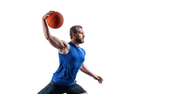 muscular sportsman play dunk basketball in studio. professional sportsman play basketball with dunk ball. sportsman play dunk basketball in sportswear. sportsman play dunk basketball isolated on white - Foto, afbeelding