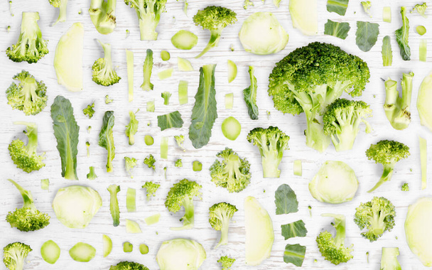 Broccoli vegetable piece, slice and leaf collection. Flat lay, seamless abstract background. - Фото, изображение