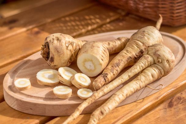 parsnip - sliced parsnip root on a cutting board on a wooden table - Photo, Image