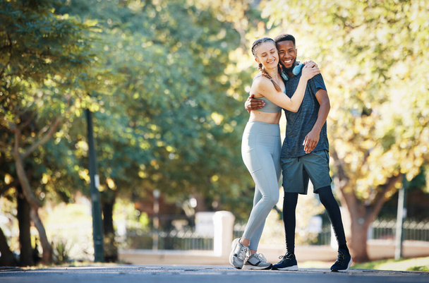 Workout, couple and hug in park portrait for exercise, fitness and walk break with smile for affection. Interracial, love and wellness of happy people dating on cardio rest together in New York - Photo, Image