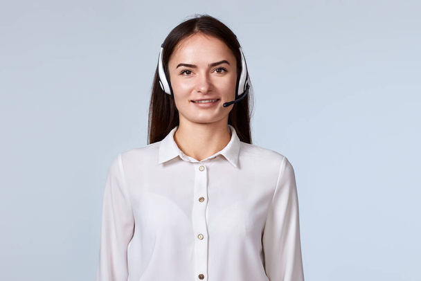 friendly smiling woman with headset is consulting clients online. Call center, business people concept - Photo, Image
