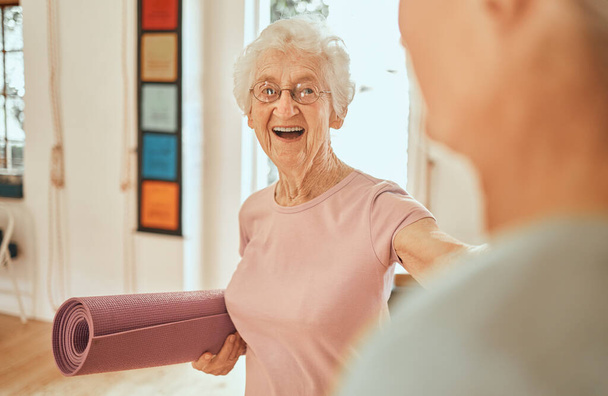 Yoga, Fitness und Workout mit einer Seniorin, die in einem Wellness-Kurs eine Gymnastikmatte in der Hand hält. Pilates, Training und Ganzheitlichkeit mit einer reifen Frau im Studio für psychische Gesundheit oder Lifestyle-Balance. - Foto, Bild