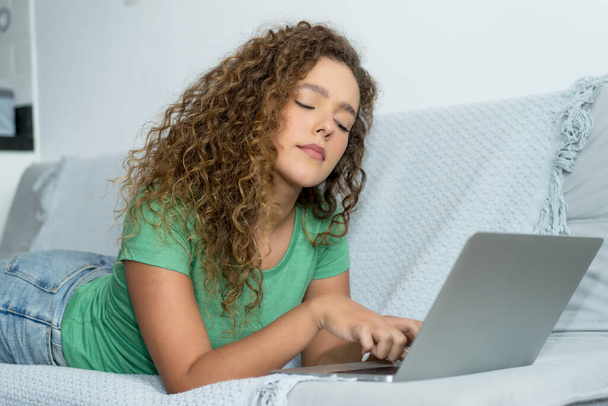 Young adult caucasian woman learning at computer indoors at home - Photo, Image