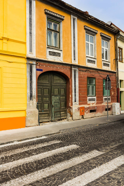 Pedestrian crossing towards an old and colored building - Foto, immagini