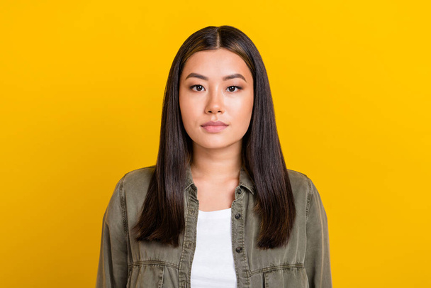 Photo of good mood serious gorgeous woman with straight hairdo dressed gray shirt look at camera isolated on yellow color background. - Фото, изображение