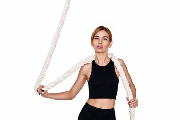 Sporty slim blonde woman in sportswear with rope on white background - Zdjęcie, obraz
