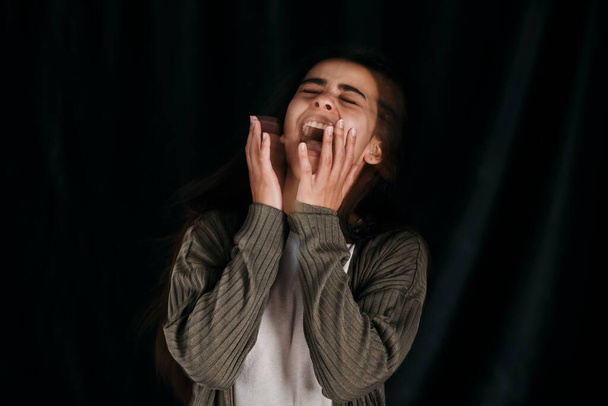 Woman, stress or screaming on black background in studio in mental health, anxiety or bipolar disorder rehabilitation. Anxiety, shouting or depression for burnout person on psychology mockup backdrop. - Фото, зображення