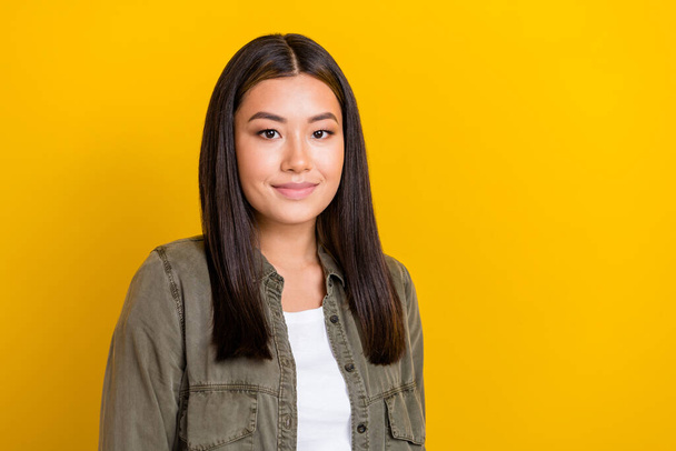 Photo of optimistic cute lovely adorable woman with straight hairdo dressed gray shirt smiling isolated on yellow color background. - Fotó, kép