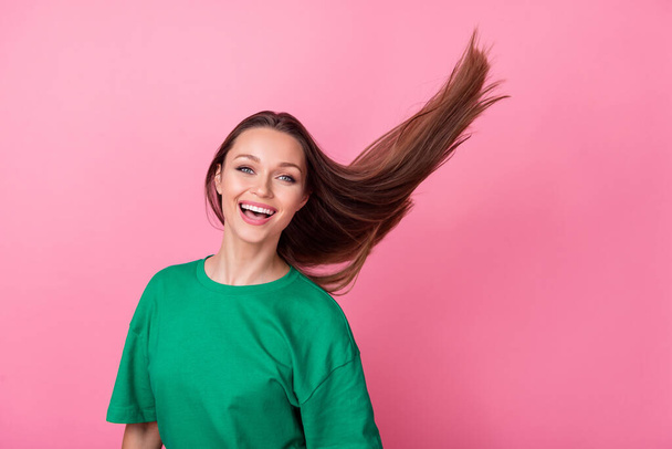 Photo of nice adorable pretty good mood girl with long hairstyle dressed green t-shirt beauty salon ad isolated on pink color background. - Фото, зображення
