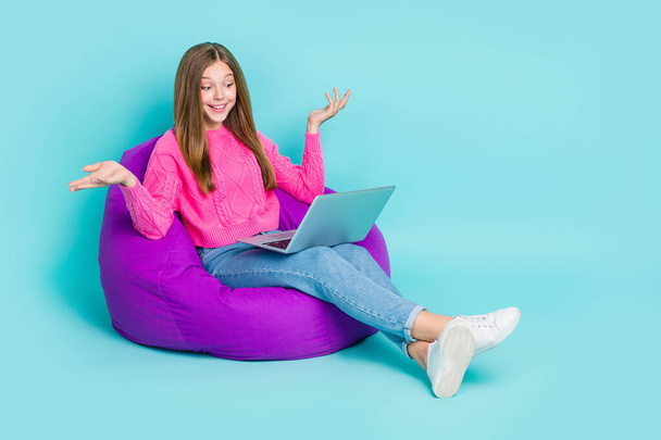 Full length photo of lovely pretty lady sit comfort chair chatting friends followers empty space isolated on cyan color background. - Фото, изображение