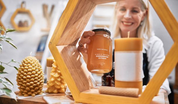 Mature woman, honey shop and shelf order in organic bees product sales, natural medical food or healthy retail stock. Smile, happy and small business store owner with grocery promotion on ingredient. - Photo, Image