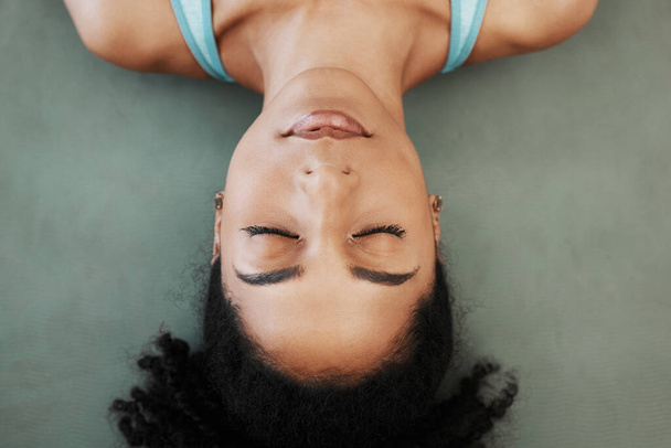 Black woman, yoga and meditation training, calm mindset and zen balance on the floor, top view and chakra. Female wellness, mental health and praying with freedom, mindfulness and relax with faith. - Photo, image