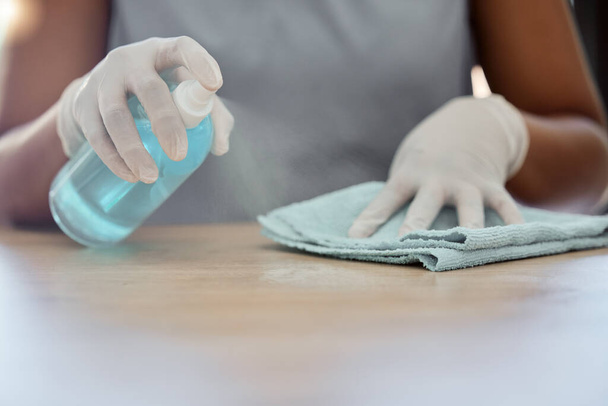 Cleaning, table and woman with spray bottle, cloth and dusting furniture in home. Closeup hands of cleaner, housekeeper and maid, surface disinfection and liquid detergent product for bacteria safety. - Foto, Imagen