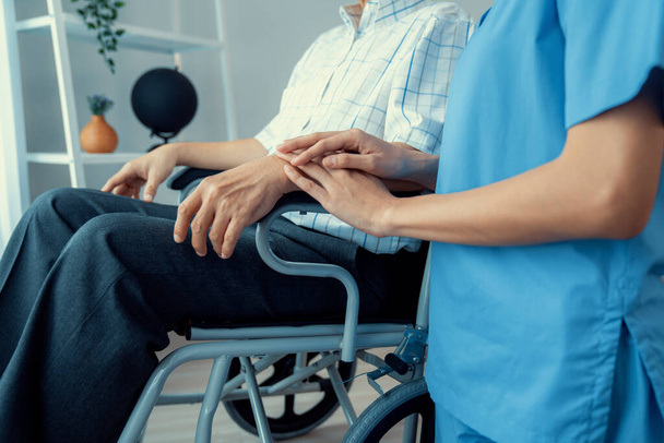 Caring nurse and a contented senior man in a wheel chair at home, nursing house. Medical for elderly patient, home care for pensioners. - Foto, Bild