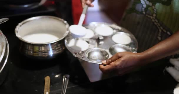  nainen käsi ruoanlaitto Idlis Suosittu Etelä-Intian aamiainen kasvisruokaa Kerala Tamil Nadu Intiassa Sri Lanka. terve höyrytetty riisi kakkuja höyrytetty pyöreä kakku. Laadukas 4k kuvamateriaalia - Materiaali, video
