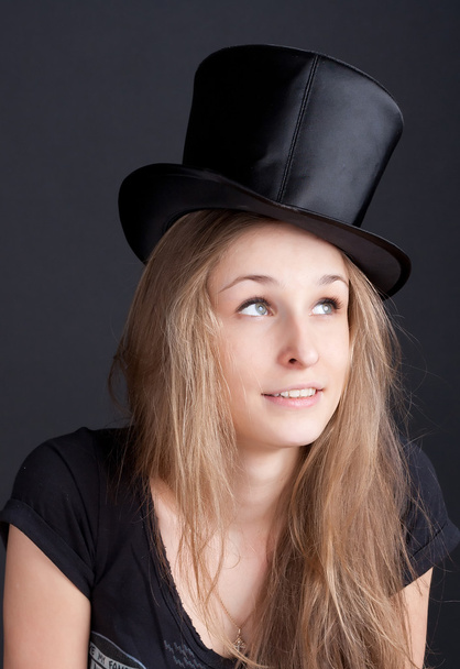 Beautiful smiling girl in a black hat - Photo, Image