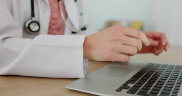 Hands, laptop and healthcare with a doctor typing an email or diagnosis report in an office of a hospital. Computer, medical and research with a female health professional working online in a clinic. - Кадри, відео