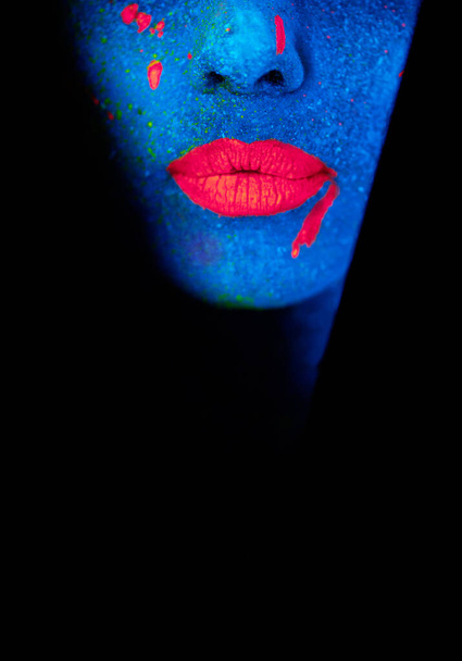 The woman of your dreams. a young woman posing with neon paint on her face - Foto, Imagen