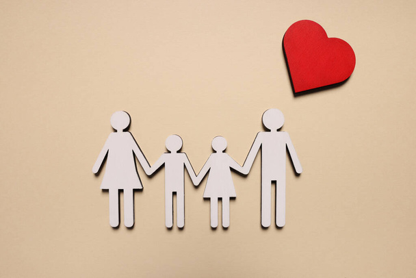 Figures of family and heart on beige background, top view. Insurance concept - Photo, Image
