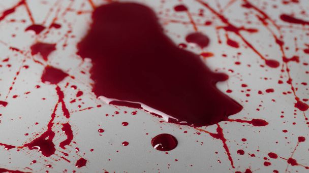 Stain and splashes of blood on light grey background, closeup - Φωτογραφία, εικόνα