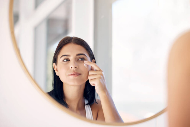 Mirror reflection of woman with skincare cream, spa lotion or dermatology ointment for melasma or acne treatment. Bathroom facial routine, healthcare and face of girl apply cosmetics beauty product. - Foto, Imagem