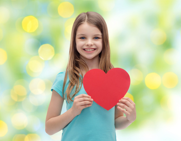 smiling little girl with red heart - Fotó, kép