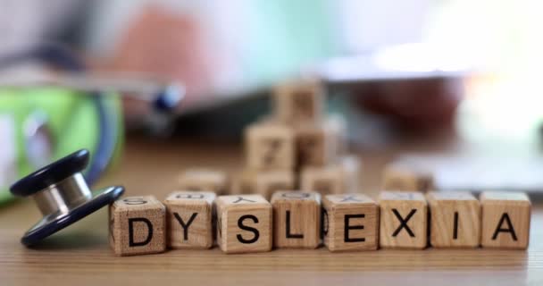 Dyslexie op houten blokjes in de kliniek, close-up, oppervlakkige focus. Medische correctie, logopedist - Video
