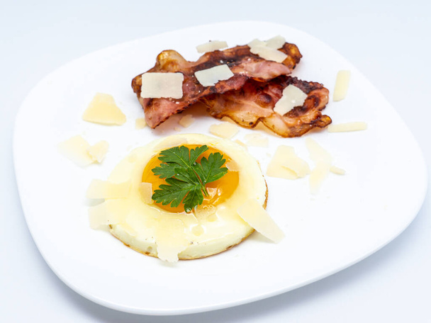 fried eggs with bacon on white plate - Photo, Image
