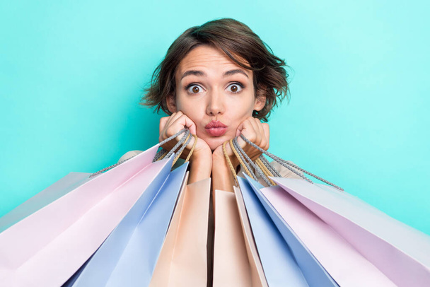 Close up photo of pretty cute lady fashionista client customer buy new trendy clothes hiding behind bags isolated on cyan color background. - Valokuva, kuva