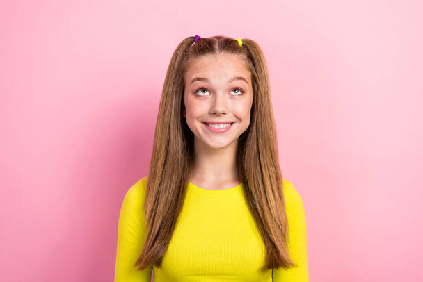 Photo of nice cute pleasant schoolgirl with ponytails dressed yellow long sleeve look empty space isolated on yellow color background. - Φωτογραφία, εικόνα
