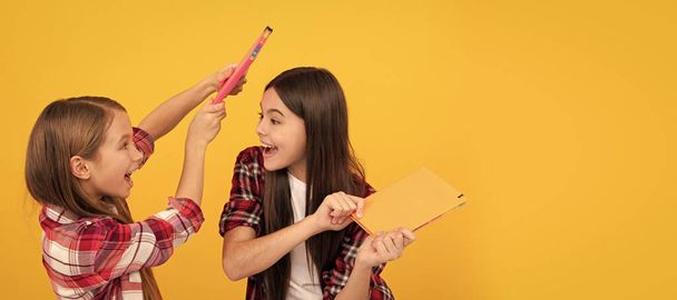 School girls friends. cheerful children in casual checkered shirt having fun with notebooks, best friend. Banner of school girl student. Schoolgirl pupil portrait with copy space - Photo, Image