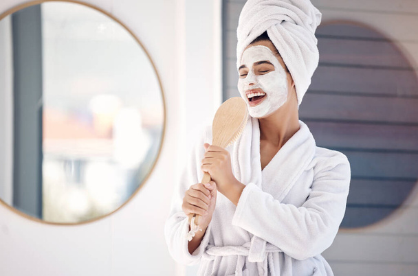 Skincare, bathroom and singing woman in face mask for cosmetics, beauty and wellness happy with benefits or product results. Skin care dermatology, facial cleaning mask and fun music girl in morning. - Foto, Imagem